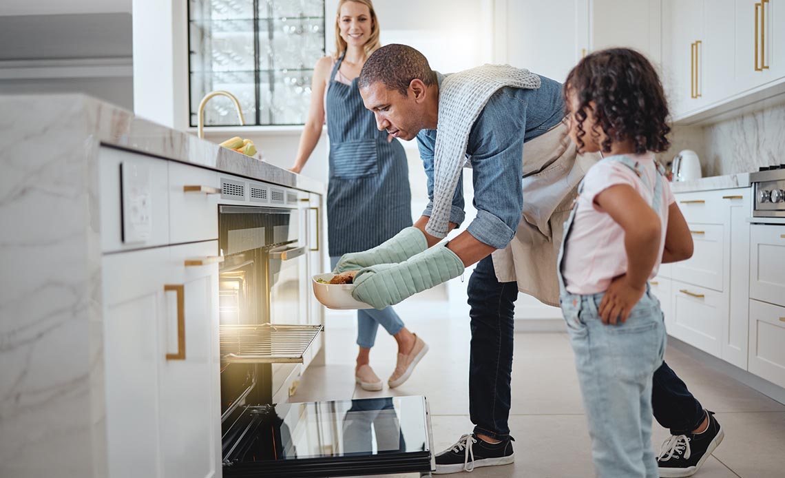 father cooking in oven